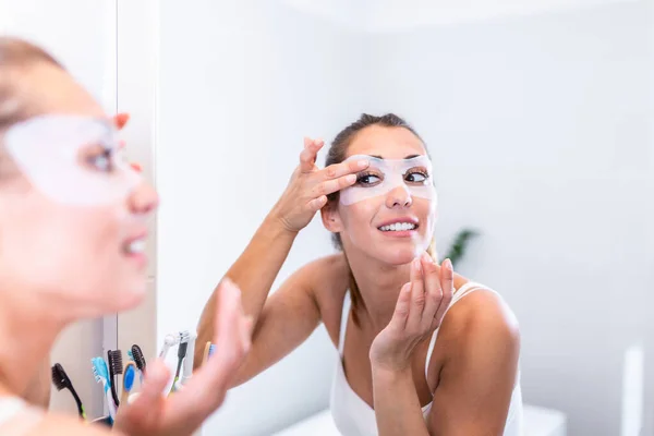 Young Beautiful Girl Applying Facial Mask Skin Looking Mirror Bathroom — ストック写真