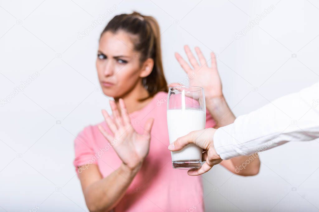 Woman feels bad, has an upset stomach, bloating due to lactose intolerance. Dairy intolerant person. Health care concept. Lactose intolerance and dairy products