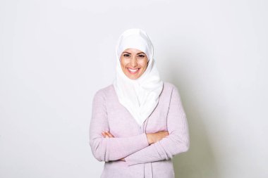 Portrait of pretty young arab muslim woman in head scarf smile. Portrait closeup of muslim woman 20s in hijab smiling isolated over white background.