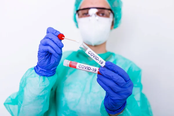 COVID-19 Nasal swab laboratory test in hospital lab, Nurse holding test tube with blood for 2019-nCoV analyzing. Novel Chinese Coronavirus blood test Concept.