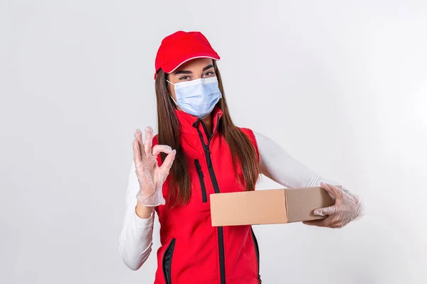 Delivery woman holding cardboard boxes in rubber gloves and medical mask. copy space. Fast and free Delivery transport . Online shopping and Express delivery