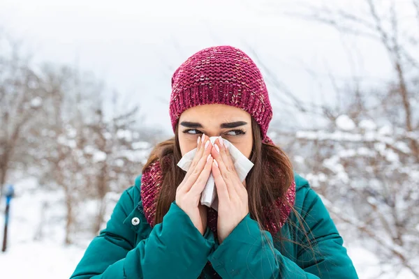 Young Woman Blowing Tissue Cold Winter Snowy Mountain Background Portrait — Stockfoto
