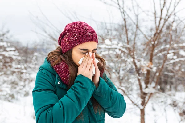 Young Woman Blowing Tissue Cold Winter Snowy Mountain Background Portrait — Stockfoto