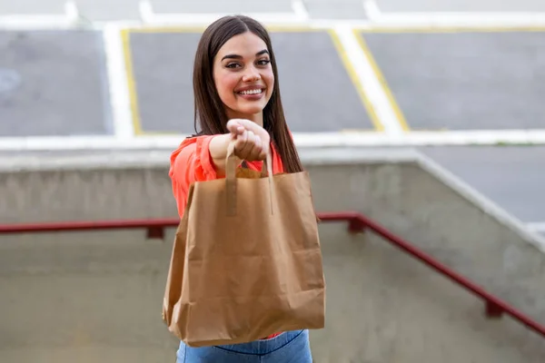 Express grocery delivery service. Smiling young woman looking at camera holding eco bag deliver grocery food delivery social donation