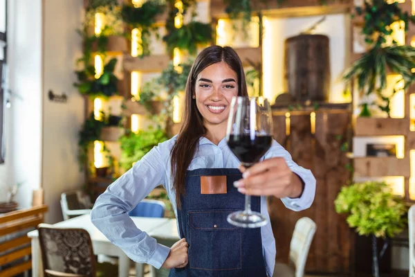 Young Beautiful Waitress Wearing Apron Holding Glass Red Wine One — Stok fotoğraf