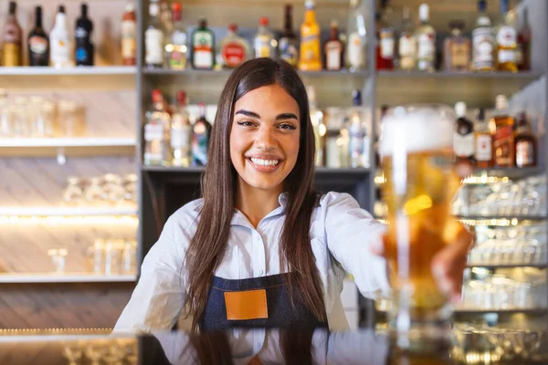 Beautiful Smiling Female Bartender Serving Draft Beer Bar Counter Shelves — Stok fotoğraf