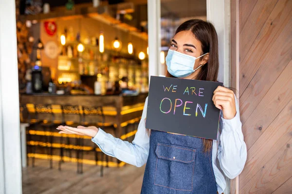 Happy Female Waitress Protective Face Mask Holding Open Sign While — Foto de Stock