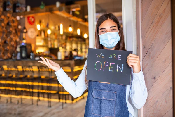 Happy Female Waitress Protective Face Mask Holding Open Sign While — Foto de Stock