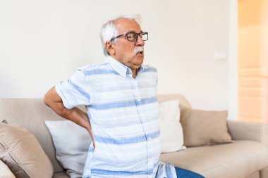 Senior man suffering from pain in back. Elderly man having discus hernia