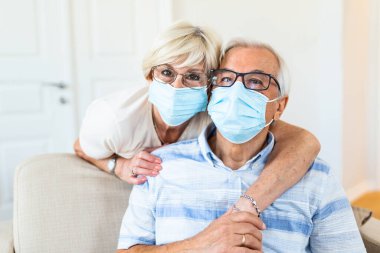 Senior couple wearing medical face mask and recovery from the illness at the home