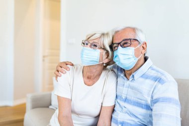Close up portrait of sick elderly woman and man with medical facial mask