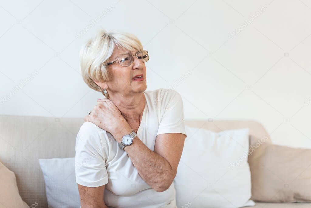 Close up of sad senior lady with neckache. Senior woman with chronic pain syndrome fibromyalgia suffering from acute neckaches. Senior woman suffering from neck pain