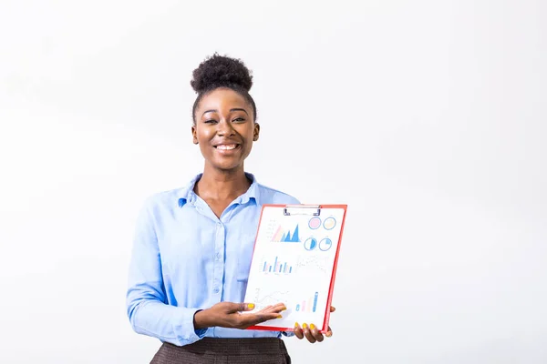 African American excited smiling female working on project pointing at chart of project. Young business woman showing the upward trend of a graphic chart