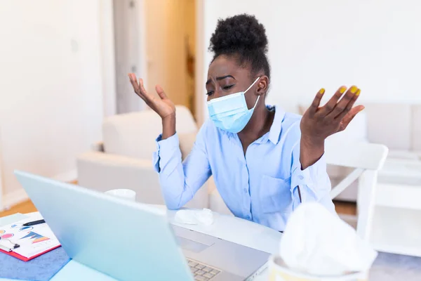 Safety during COVID-19 pandemic. African American Businesswoman wearing mask in the office during COVID-19 pandemic. Businesswoman in medical face protection mask. Business woman with mask