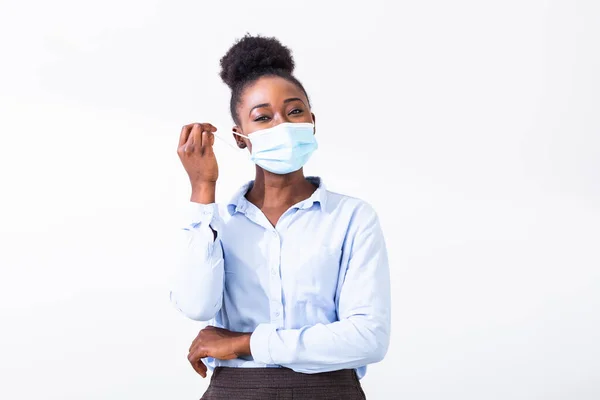 Masked woman - protection against influenza virus. African - American woman wearing mask for protect. Woman wear with protective face mask at home. Stop the virus and epidemic diseases.