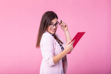 Young beautiful smiling woman in glasses holding pen, isolated on background. Business concept with clipboard and document in hands