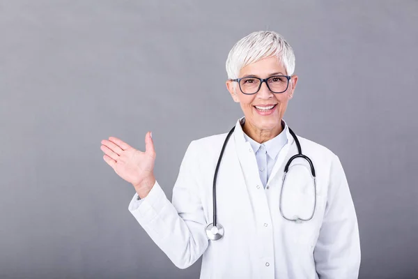 Doctor Senior Woman Medical Professional Pointing One Direction Isolated Blue — Stockfoto