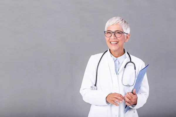 Female mature doctor holding medical records and stethoscope. Healthcare and medical concept. Medicine doctor with stethoscope isolated on background.