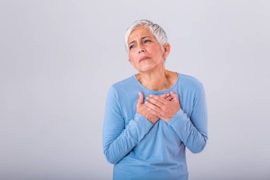 Woman having a pain in the heart area. Heart Attack. Painful Chest. Health Care, Medical Concept. High Resolution. Woman having heart attack at home