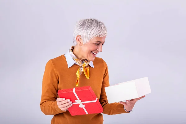 Portrait Happy Smiling Mature Woman Opening Gift Box Isolated Gray — Fotografia de Stock