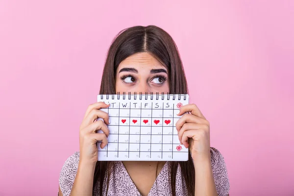 Portrait Funny Young Girl Hiding Menstrual Periods Calendar Looking Away — Zdjęcie stockowe