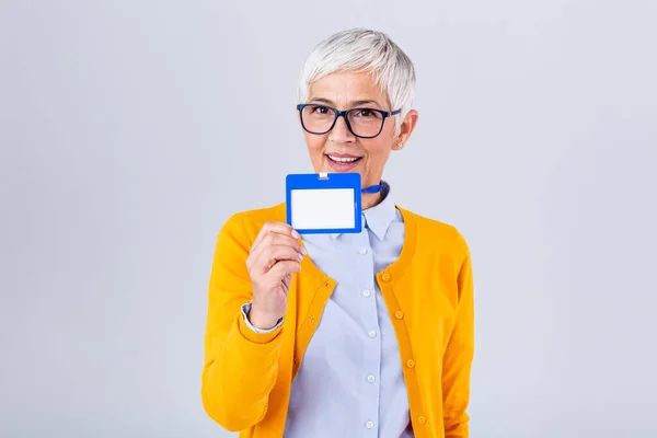 Woman wear blank vertical ID badge mockup, stand isolated. Name tag on neck and chest. Person identity label. Women in shirt uniform with empty id card mock up. Bussinesswoman lanyard design.