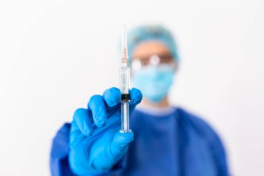 Coronavirus aşısı COVID-19 'un geliştirilmesi ve yaratılması. Coronavirus aşısı kavramı doktor mavi aşı kavanozunun elinde. Aşı Coronavirus 'a karşı savaş kavramı.