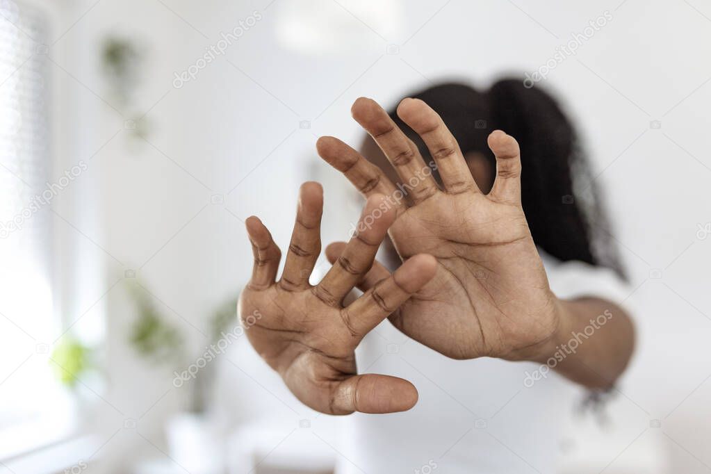 woman raised her hand for dissuade, campaign stop violence against women. African American woman raised her hand for dissuade with copy space