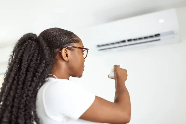 Happy Young Woman Holding Remote Control Relaxing Air Conditioner — Stock Photo, Image