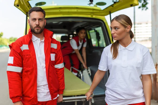 Mladí Zdravotníci Přesouvají Sanitku Auta Záchranáři Uniformě Vynášejí Nosítka Vozu — Stock fotografie