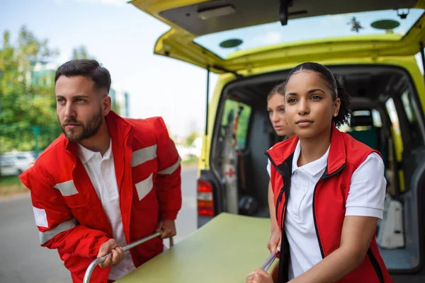 Paramédicos Con Una Camilla Cerca Una Ambulancia Paramédicos Uniforme Sacando — Foto de Stock