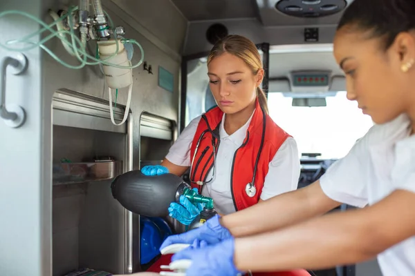 Paramedic using defibrillator (AED) in conducting a basic cardiopulmonary resuscitation. Emergency Care Assistant Putting Silicone Manual Resuscitators in an Ambulance.