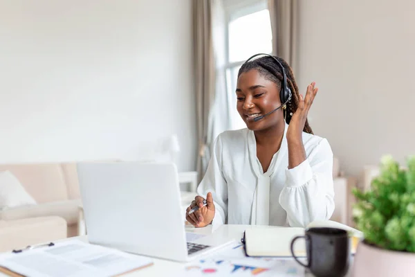 African elegant female entrepreneur discussing while having a conference call Portrait of confident ethnicity female employee looking at camera talking on video call in the home office.