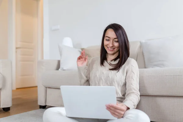 Portrait of casual asian woman relax sit on the floor use computer laptop. Thinking asian Freelance small business owner sme virtual, work from home concept.