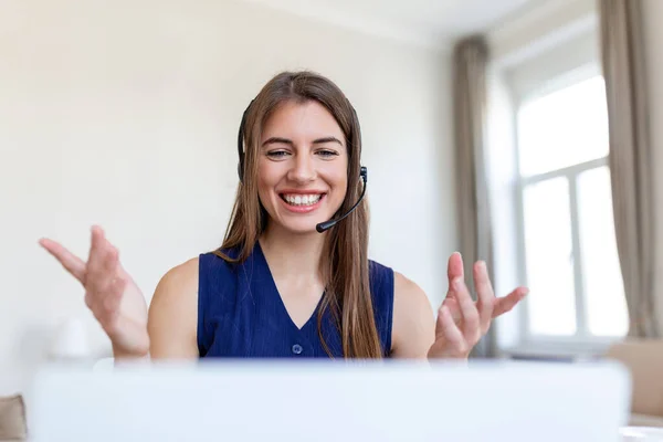 Shot of a businesswoman on a video call while sitting at her desk .Cropped shot of an attractive young woman using her laptop to make a video call at home