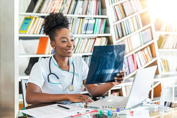 Woman doctor in hospital looking at x-ray film healthcare, roentgen, people and medicine concept. Radiography concept. radiology female doctor examining x ray film of patient at hospital room.