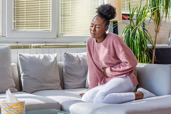 Young Black Woman Suffering Stomachache Sofa Home Woman Sitting Bed — 스톡 사진