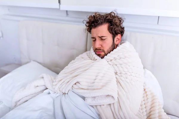 stock image Sick day at home. Handsome Man has fever and common cold. Cough. Closeup Of Young Man Caught Cold Or Flu Illness. Portrait Of Unhealthy man Feeling Pain In Throat.