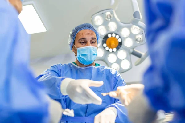 손으로 수술하는 인스트루 내보낸다 외과의는 작전을 의사들이 수술을 진행하다 — 스톡 사진
