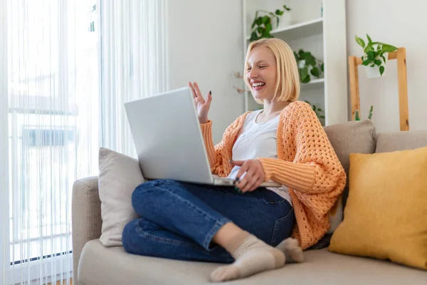 Young woman on a video call from home with her friends while in quarantine. Cropped shot of an attractive young woman using her laptop to make a video call at home