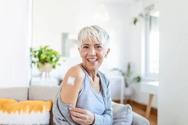 Adhesive bandage on arm after injection vaccine or medicine,ADHESIVE BANDAGES PLASTER - Medical Equipment,Soft focus Adhesive bandage on a female brachium after covid-19 vaccination