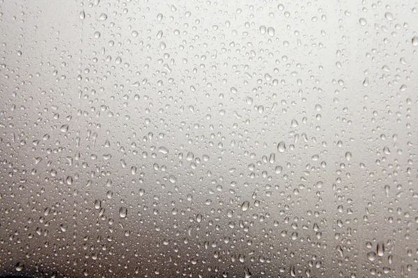 Falling raindrops on glass — Stock Photo, Image