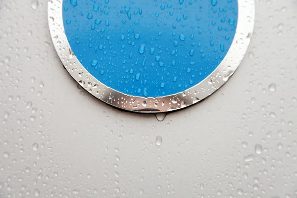Symbol and raindrops on glass — Stock Photo, Image