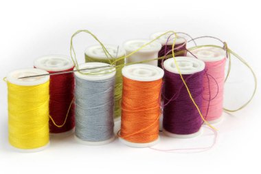 various colors of thread and sewing needle clipart