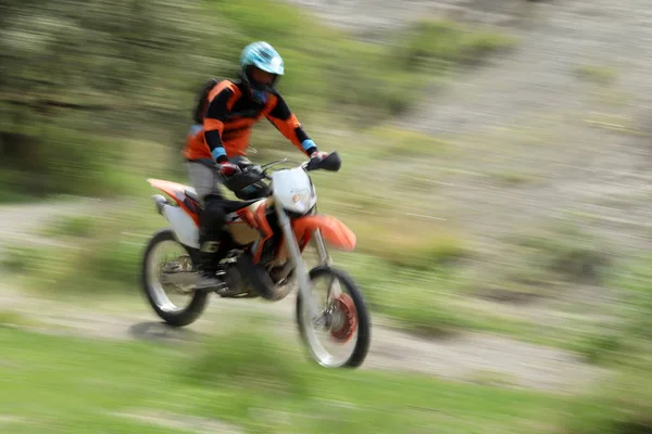 Blurry image of motorcycle riders during motocross race