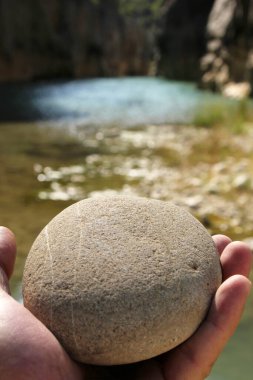 A hand holding a stone. Man and nature.