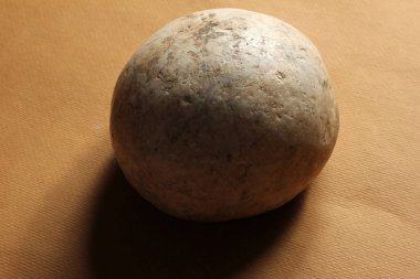 round stone on colored background