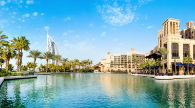 Dubai, Birleşik Arap Emirlikleri - 28 Mart 2022: Dubai 'deki en ünlü tatil beldesi Madinat Jumeirah' da Arap tarzı binalar, kanallar ve tropikal manzaralı güzel bir lüks otel