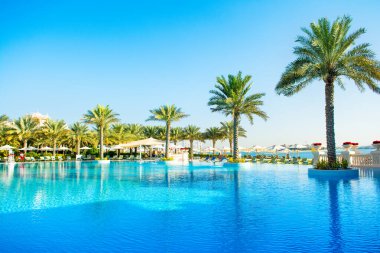 Dubai, United Arab Emirates - April 18, 2022: Luxury beach resort on Palm Jumeirah with swimming pool and relaxation area
