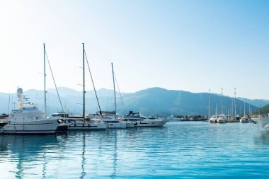 Tivat, Montenegro - June 28, 2022: Sunset view of the yacht marina in Porto Montenegro with waterfront residences and  the beautiful promenade